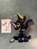 Front view of the Halloween black cat with its included original colored hand-drawn sketch; the stone tag is a display prop