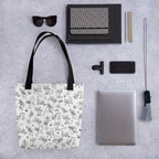 Printful flat-lay mockup of the Yizcho Cat Parade tote beside a laptop and desk accessories; props are not included.