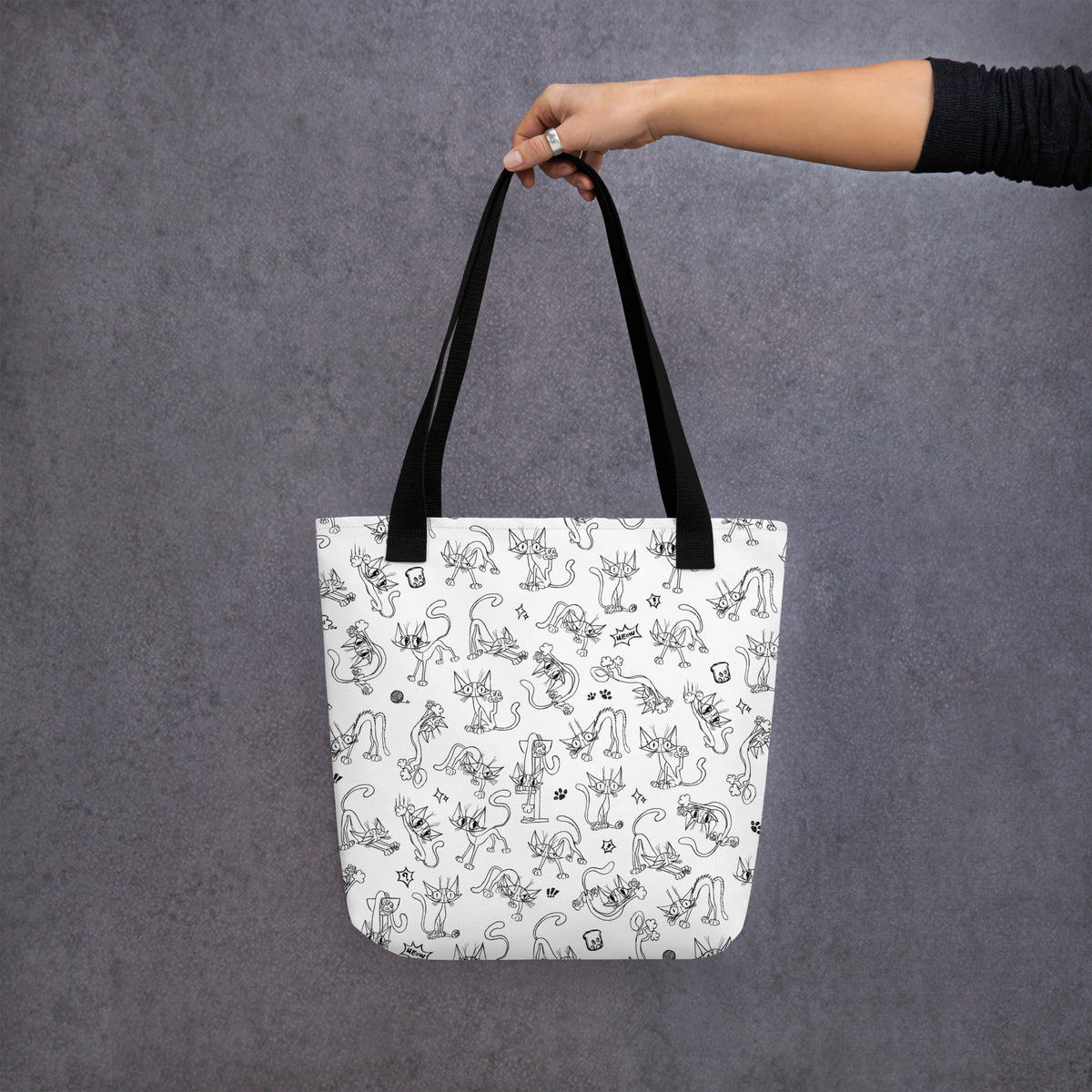 Printful mockup of the Yizcho Cat Parade tote held against a grey backdrop.
