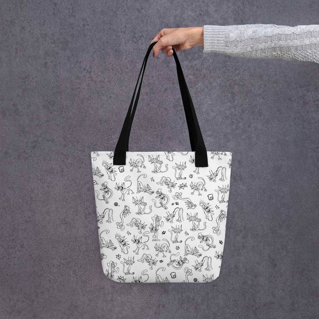 Printful mockup of the Yizcho Cat Parade tote held by a hand in a grey sleeve.