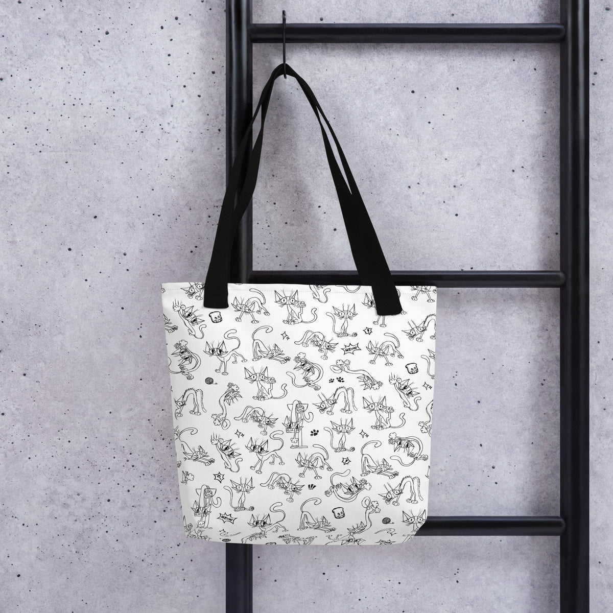 Printful lifestyle mockup of the Yizcho Cat Parade tote hanging from a black ladder.