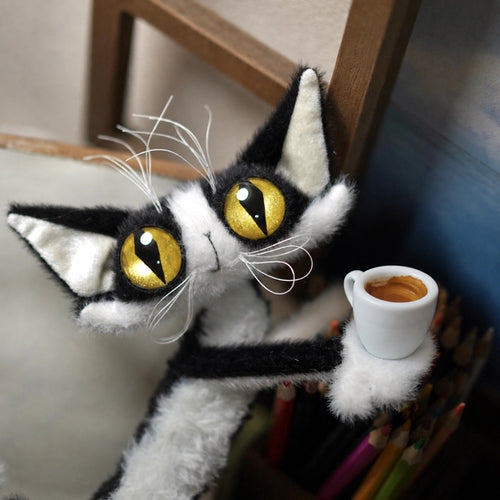 Yizcho cat holding a small cup of coffee