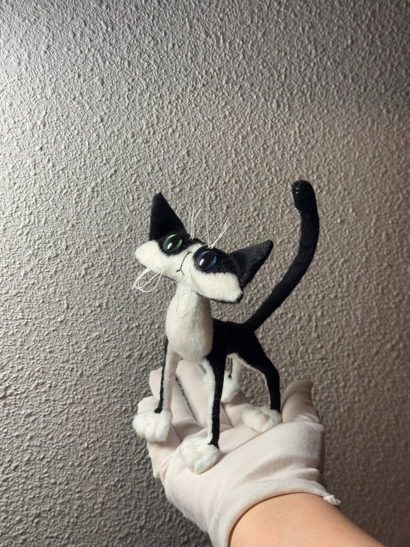 First cow cat plush with long limbs and oversized paws